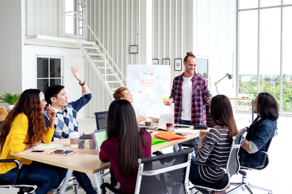 Group having a discussion around a conference table.