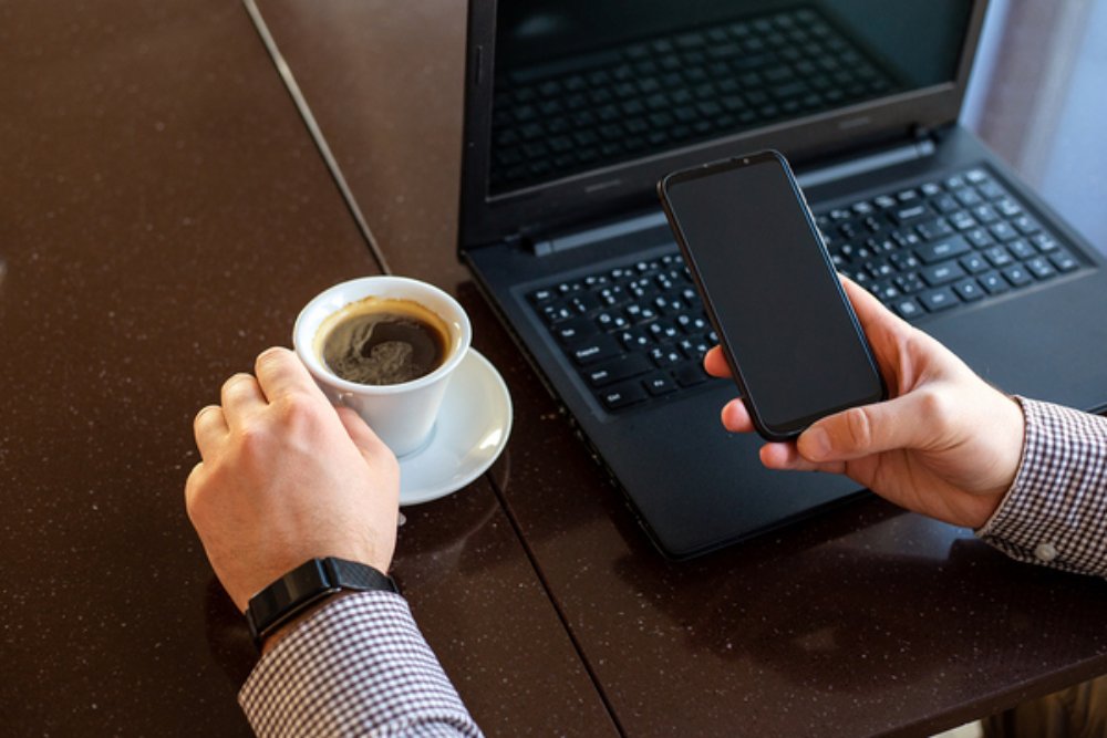 Working at a table with a laptop.